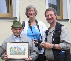 Loretta, Paul, and local man with painting of Niedersteinach